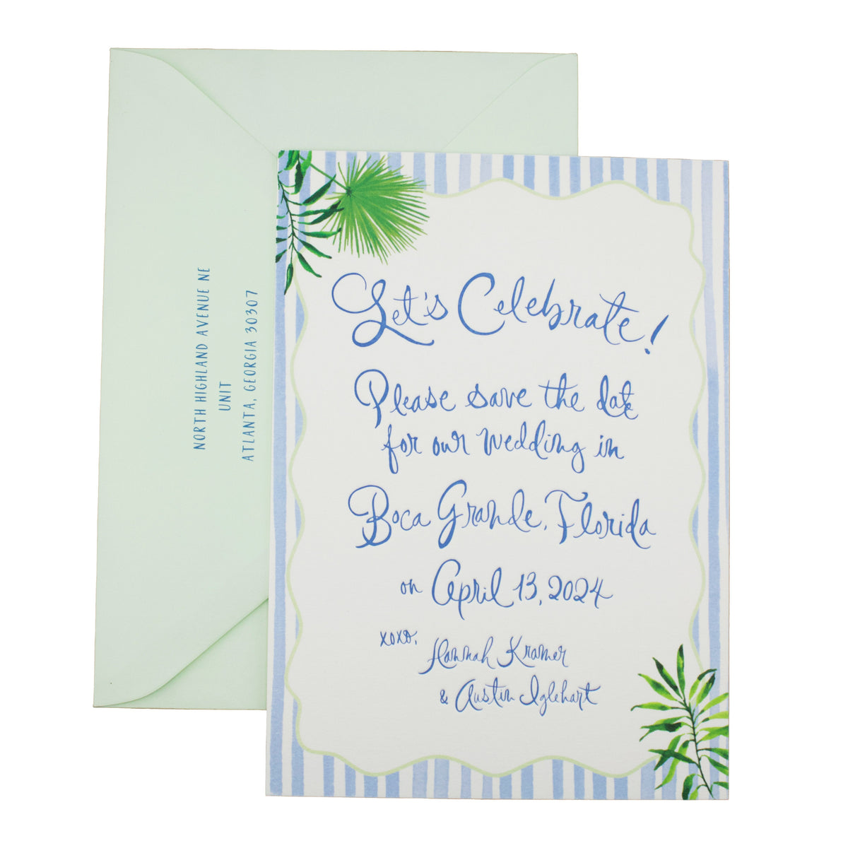 A wedding invitation with blue stripes, tropical leaf designs, and elegant custom hand calligraphy reads: Let’s Celebrate! Please save the date for our wedding in Boca Grande, Florida on April 13, 2024. An addressed envelope sits behind it.