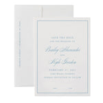 A white personalized paper save the date card with blue text announces the wedding of Bailey Alexander and Kyle Gordon on February 27, 2021, in Lake Wales, Florida, with envelope liners peeking from behind.