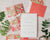 Colorful wedding invitation set with floral designs on a neutral background