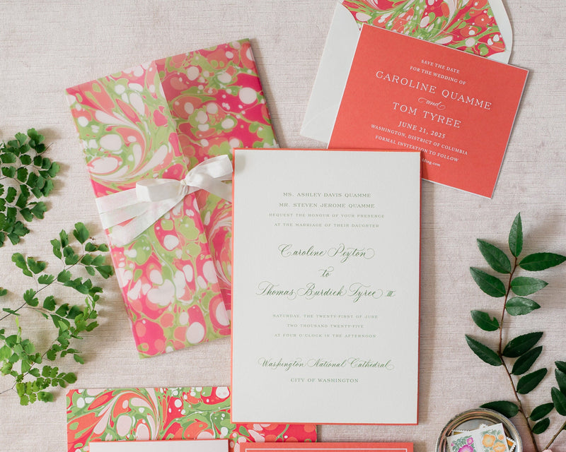 Colorful wedding invitation set with floral designs on a neutral background