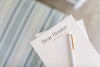 Photo of stationery with Dear Elouise logo and a white pen
