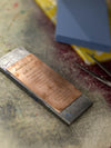 Metal plaque with engraved text on a textured surface