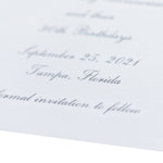 Close-up of an elegant white engraved card with cursive text, featuring the date September 25, 2021, Tampa, Florida, and the phrase "formal invitation to follow" as a beautiful save the date.
