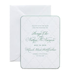 A white letterpress wedding save-the-date card with elegant green script font announces the wedding of Sonya Cho and Nathan McNamara on May 19, 2018, in Kiawah Island, South Carolina. An envelope sits behind this personalized paper keepsake.